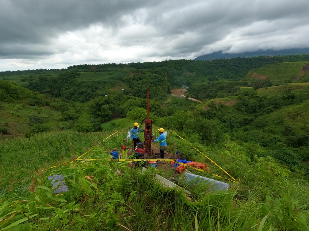 MEGA Philippines crew conducting geotechnical drilling on a hillside for a proposed hydroelectric facility
